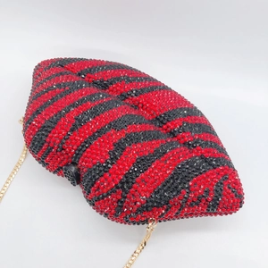 Zebra striped lip shaped clutch bag with red and black crystals and gold chain strap