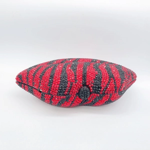 Close-up of zebra pattern red and black rhinestones on luxury clutch bag with metal clasp