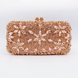 Detailed macro view of champagne gold evening clutch with sunflower rhinestone patterns