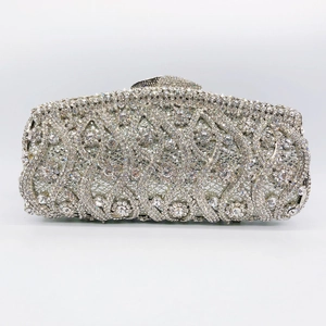 Detailed close-up of a silver clutch bag featuring hollowed-out sparkling rhinestones