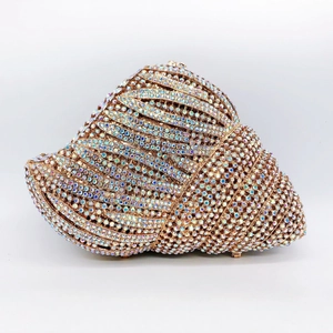 Macro shot of shell-shaped clutch bag encrusted with shimmering AB crystals