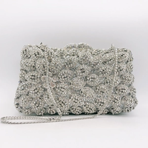 Macro detail of silver rhinestone evening clutch showing intricate floral stone patterns