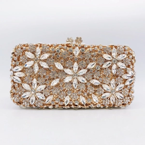 Macro view of crystal floral evening clutch with hollow rhinestones and gold metal frame