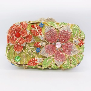 Macro view of luxury evening clutch bag with colorful rhinestones in floral patterns