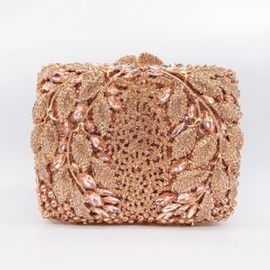 Detail of luxurious champagne gold evening clutch with hollow rhinestones and pink crystals