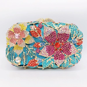 Exquisite floral rhinestone pattern detail on blue glitter evening clutch with gold frame