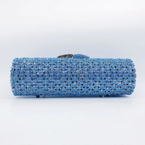 Detail of a cylindrical evening clutch bag with sparkling blue rhinestones and silver metal clasp