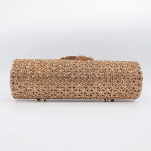 Macro view of cylindrical evening clutch bag with champagne rhinestones and metal base