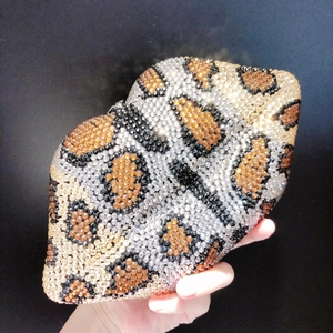 Macro shot of leopard print rhinestones on a lip-shaped evening clutch bag
