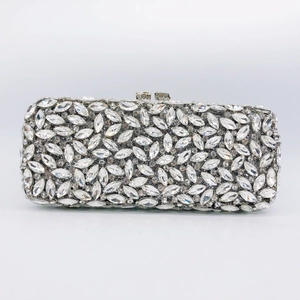 Detailed view of silver evening clutch bag with marquise-cut rhinestones and metal clasp