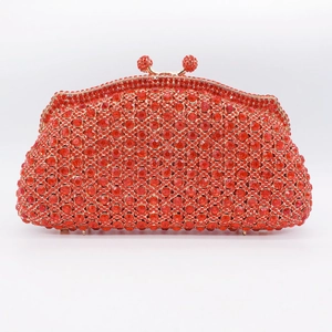 Detail of red rhinestone evening clutch bag with gold frame and double crystal clasp
