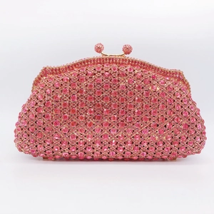 Detail of pink crystal rhinestones and gold metal clasp on a formal evening clutch bag