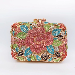 Detailed macro shot of a crystal floral clutch bag with red rose rhinestone pattern