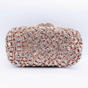 Close-up of luxury rose gold evening clutch featuring hollowed weave and sparkling crystals