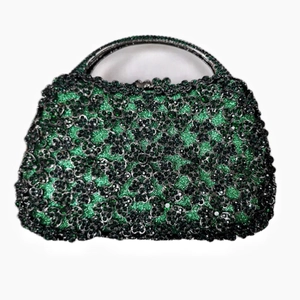 Detail of luxury evening clutch with green gradient crystals and metal handle