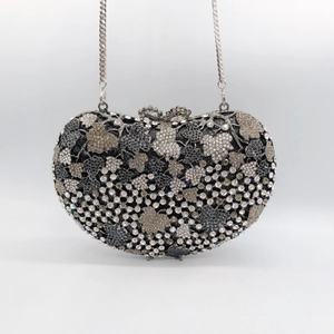 Detailed view of the sparkling rhinestone leaf pattern on champagne evening clutch bag