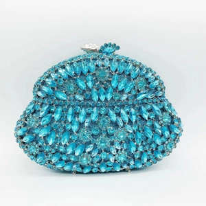 Macro detail of luxury mermaid shell clutch with hand-set blue crystals and jewels