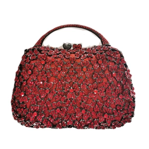 Close-up of red floral rhinestone evening bag with heart clasp and hard handle