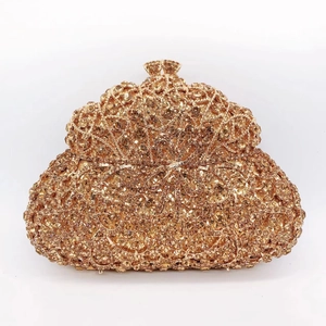 Detailed macro of luxury champagne gold evening clutch bag with crystal bow decoration
