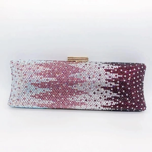 Detailed close-up of pink and purple gradient rhinestones on a luxury evening clutch bag