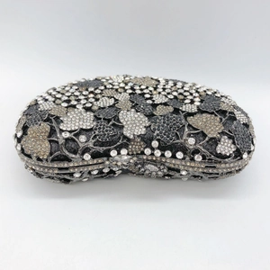 Close-up of intricate grape leaf crystal patterns on a luxury evening clutch bag