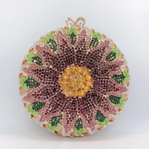 Macro detail of sunburst floral pattern with multi-color rhinestones and rose gold heart clasp