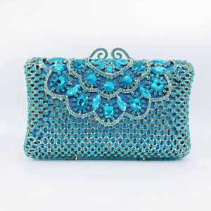 Detailed view of hollow gold clasp and sky blue crystal floral patterns on evening clutch