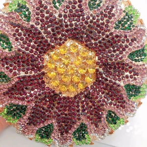 Macro shot of colorful rhinestone floral design on crystal evening clutch bag