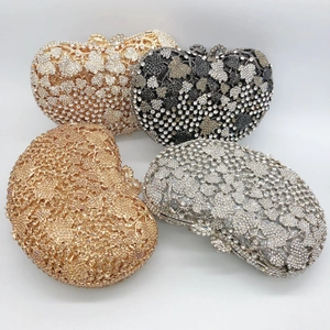 Detail of evening clutch bags with sparkling rhinestones in heart and leaf patterns