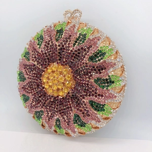 Macro detail of sunburst crystal evening bag with multicolored rhinestones and rose gold clasp
