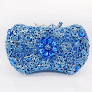 Detailed close-up of sapphire blue rhinestone clutch bag with crystal floral ornament