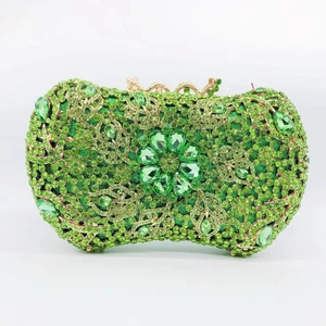 Macro shot of green rhinestone evening clutch showing intricate crystal floral patterns