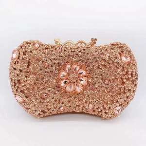 Detailed close-up of rose gold clutch with sparkling crystals and large petal gemstones