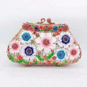 Detail of hollow metal frame with colorful floral enamel and rhinestones on clutch bag