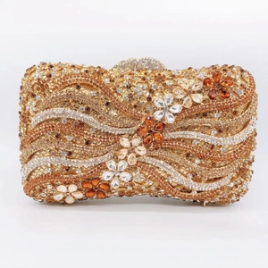 Detailed close-up of crystal evening clutch bag with amber floral rhinestone patterns