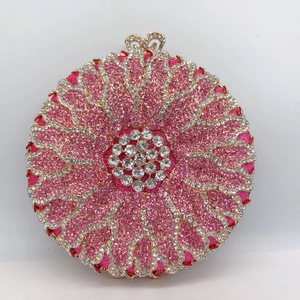 Detailed view of pink floral evening clutch with crystals and heart-shaped metal clasp
