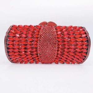 Macro shot of red marquise crystals and sparkling rhinestones on the luxury clutch bag