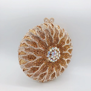 Elegant gold round evening clutch bag with radiating rhinestones and floral crystal clasp