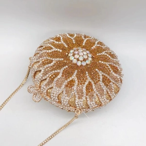 Close-up of golden sunburst pattern evening clutch with sparkling crystal rhinestones