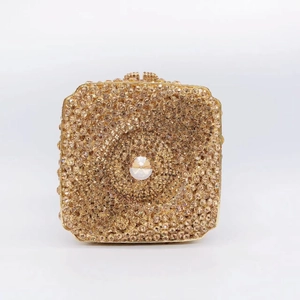 Close-up of champagne crystal clutch showing intricate wave edges and a central large gem