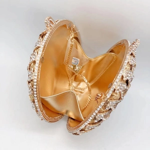 Detail view of golden clutch with sparkling rhinestones and detachable metal chain strap