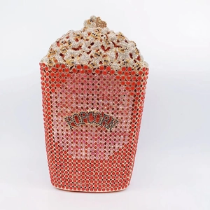 Macro detail of luxury popcorn-shaped evening clutch bag with red and pink crystals