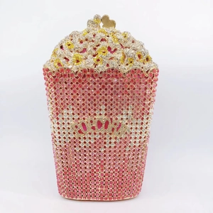 Detailed view of novelty popcorn-shaped clutch with sparkling pink and white rhinestones