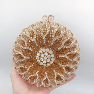 Macro shot of circular champagne gold clutch bag featuring intricate sunburst diamond patterns