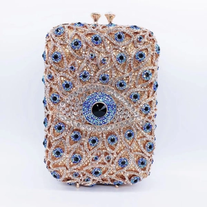 Detail showing crystal evil eye patterns on rose gold luxury evening clutch bag