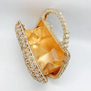 Detailed interior of luxury phoenix floral clutch with spare rhinestones and gold lining