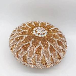 Detailed close-up of a circular evening clutch with radiant sunburst rhinestone patterns