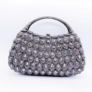 Macro detail of luxury teardrop crystal clutch bag with peacock feather pattern design