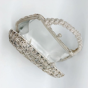 Detail of the silver rhinestone clutch with smooth satin lining and sturdy metal handle