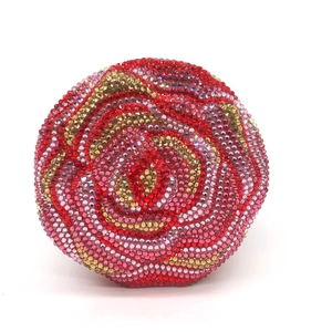 Detailed close-up of a round rose-shaped evening clutch encrusted with colorful rhinestones